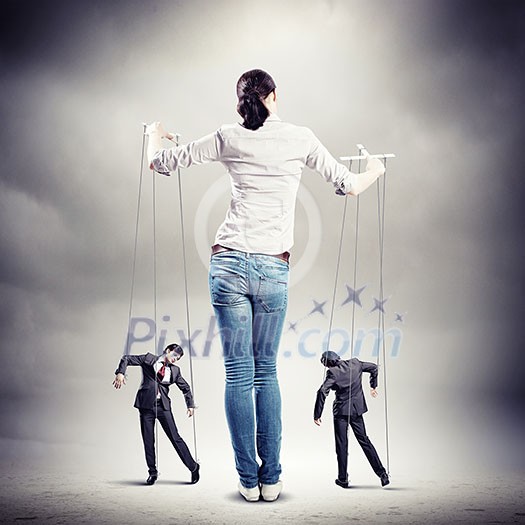 Image of pretty businesswoman puppeteer. Leadership concept Image of pretty businesswoman puppeteer. Leadership concept
