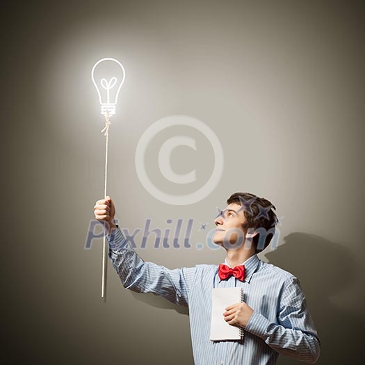 Image of young confused businessman holding notebook