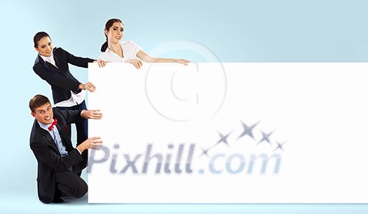 Image of three young people holding blank banner against blue background. Place for text Image of three young people holding blank banner against blue background. Place for text
