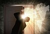 Image of young businessman opening the door