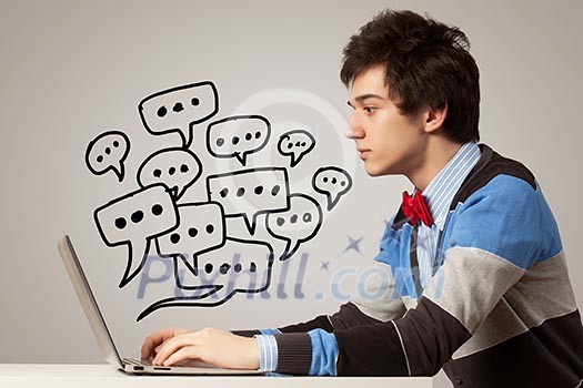 Young man in casual chatting using laptop Young man in casual chatting using laptop