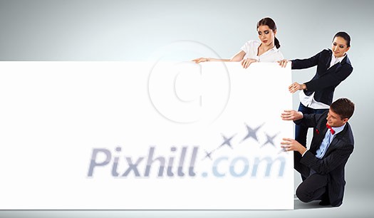 Image of three young people holding blank banner. Place for text Image of three young people holding blank banner. Place for text