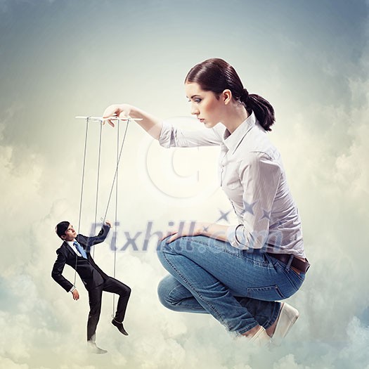 Image of pretty businesswoman puppeteer. Leadership concept Image of pretty businesswoman puppeteer. Leadership concept