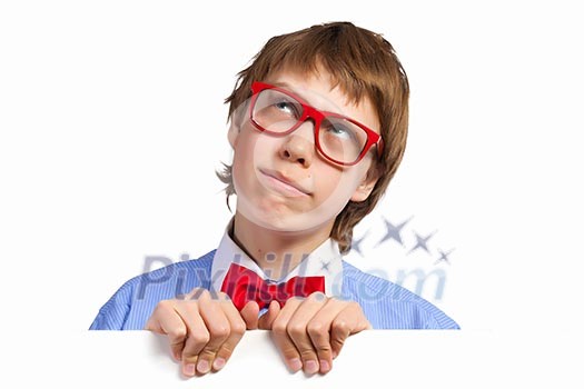 Image of young boy smiling thoughtfully holding white square. Place for advertisement Image of young boy smiling thoughtfully holding white square. Place for advertisement