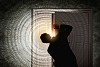 Image of young businessman standing with back opening door