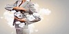 Image of young businesswoman holding alarmclock against cloudy background