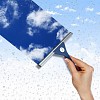 Hand cleaning window with blue sky and white clouds