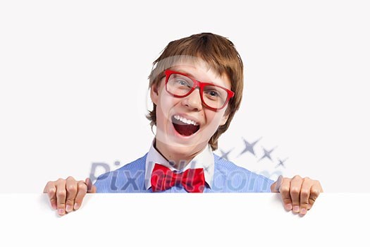 Image of young boy laughing holding white square. Place for advertisement Image of young boy laughing holding white square. Place for advertisement