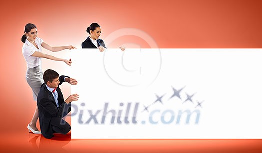 Image of three young people holding blank banner against orange background. Place for text Image of three young people holding blank banner against orange background. Place for text