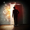 Image of young businessman standing with back opening door