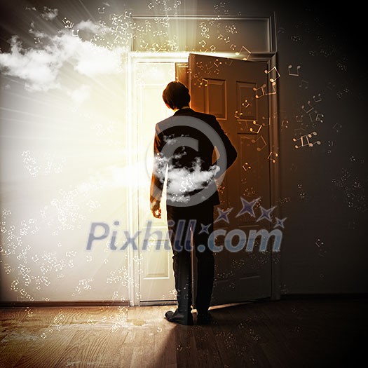 Image of young businessman standing with back opening door Image of young businessman standing with back opening door