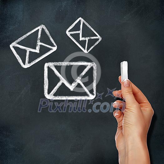 School blackboard and hand drawing mail symbol School blackboard and hand drawing mail symbol