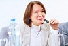 Image of businesswoman at business meeting speakig in microphone