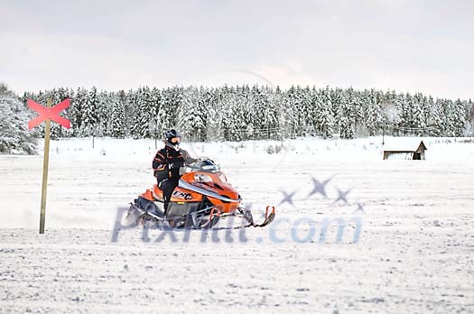 A man riding a snowmobile in a snowy landscape A man riding a snowmobile in a snowy landscape