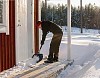 Woman shovelling snow from the porch