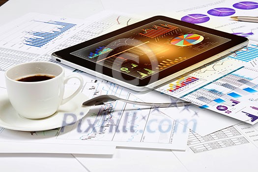 Image of cup of coffee and ipad laying on business documents