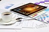 Image of cup of coffee and ipad laying on business documents