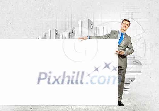 Businessman with blank banner standing against urban scenic. Place for text Businessman with blank banner standing against urban scenic. Place for text