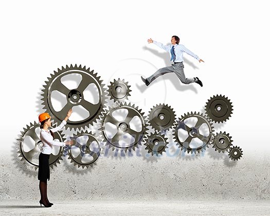 Businessman and businesswoman with cog wheel elements. Organization concept Businessman and businesswoman with cog wheel elements. Organization concept
