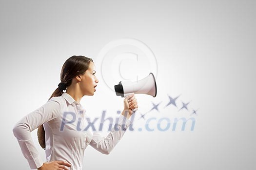 Image of young businesswoman screaming in megaphone Image of young businesswoman screaming in megaphone