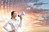 Image of young businesswoman screaming in megaphone