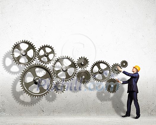 Businessman with cog wheel elements. Construction concept Businessman with cog wheel elements. Construction concept