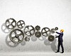 Businessman with cog wheel elements. Construction concept