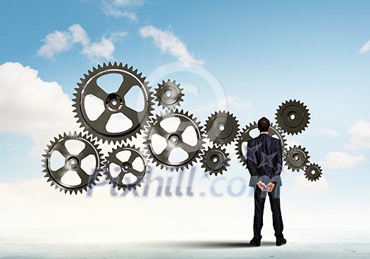Businessman with cog wheel elements. Construction concept Businessman with cog wheel elements. Construction concept
