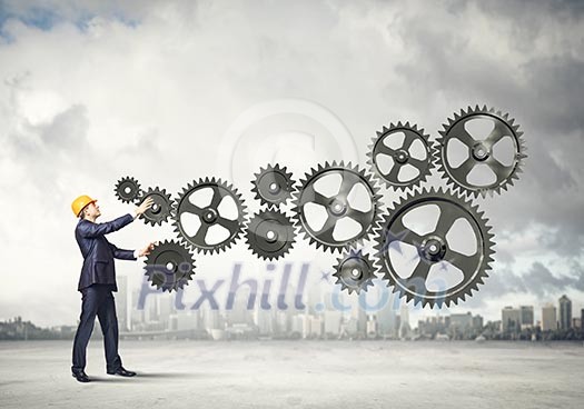 Businessman with cog wheel elements. Construction concept Businessman with cog wheel elements. Construction concept