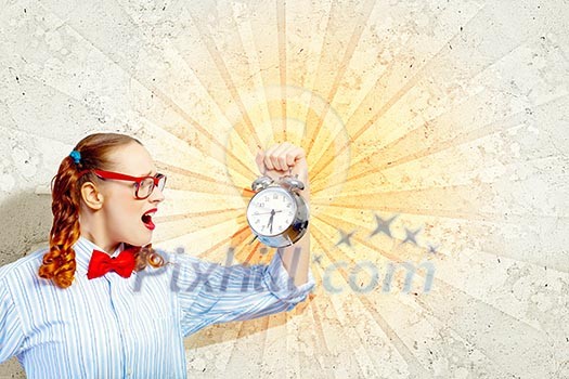 Young woman with an old-fashioned alarm clock Young woman with an old-fashioned alarm clock