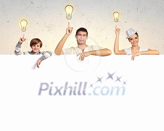 Happy young family with blank banner. Place for text Happy young family with blank banner. Place for text