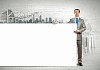 Businessman with blank banner standing against urban scenic. Place for text