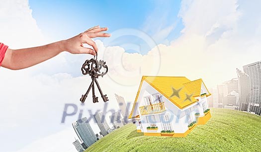 Close up image of human hand holding keys Close up image of human hand holding keys