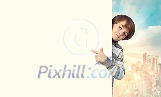Little boy holding a blank white billboard Little boy holding a blank white billboard