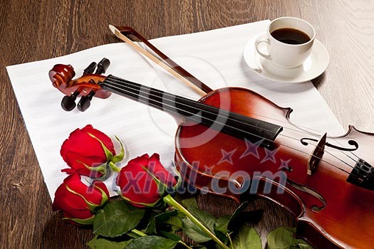 Red roses and a violin on the table Red roses and a violin on the table
