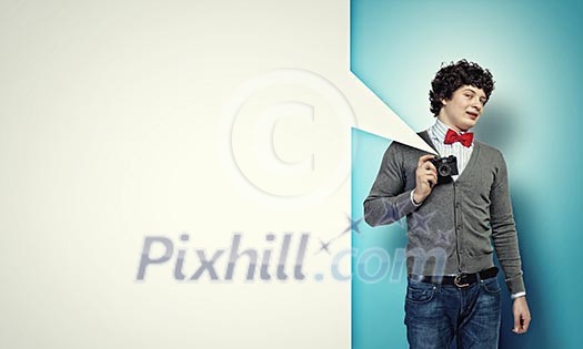 Image of young man in red tie with photo camera taking pictures Image of young man in red tie with photo camera taking pictures