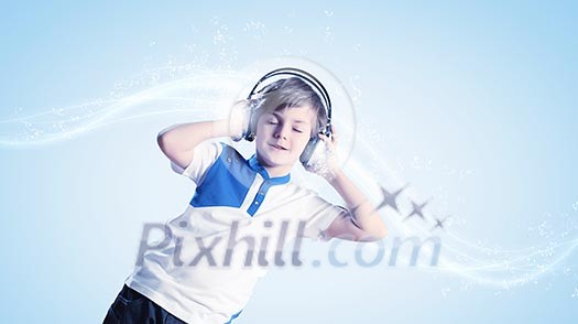 Little cute boy in headphones with eyes closed enjoying music Little cute boy in headphones with eyes closed enjoying music