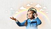 Little cute girl in headphones enjoying music