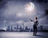 Young man and the moon symbol against polluted and ruined landscape