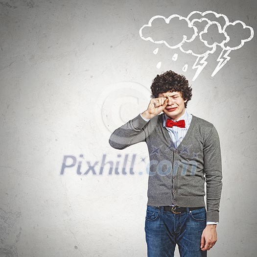 Image of young upset man in red tie crying Image of young upset man in red tie crying