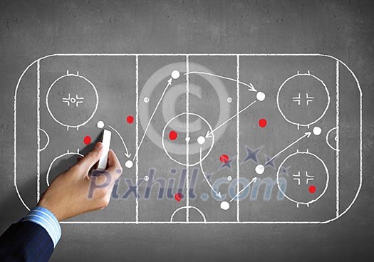 Close up image of human hand drawing hockey tactic plan Close up image of human hand drawing hockey tactic plan