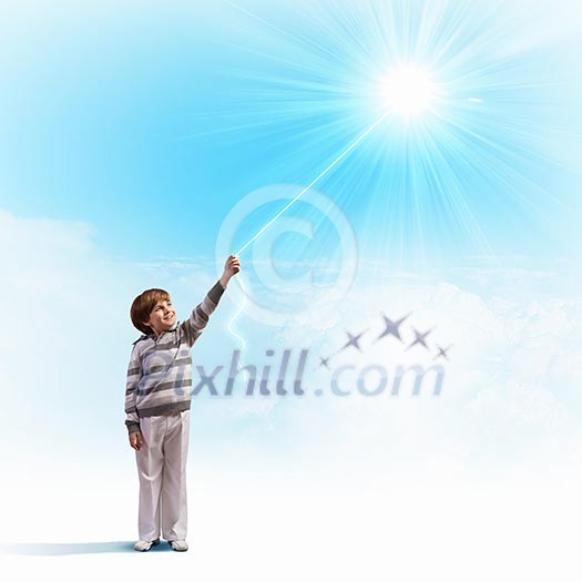 Image of little cute boy catching sun with rope Image of little cute boy catching sun with rope