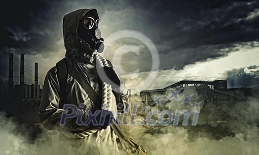 Man in gas mask against disaster background. Pollution concept Man in gas mask against disaster background. Pollution concept