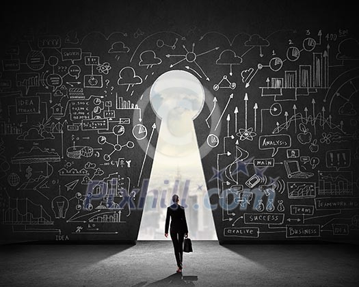 Silhouette of businesswoman against black wall with key hole Silhouette of businesswoman against black wall with key hole