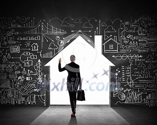 Silhouette of businesswoman against black wall with key hole Silhouette of businesswoman against black wall with key hole