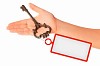 Image of key with blank label in human hand