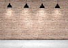 Blank brick wall with place for text illuminated by lamps above