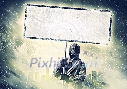 Stalker in gas mask with blank banner. Disaster concept Stalker in gas mask with blank banner. Disaster concept