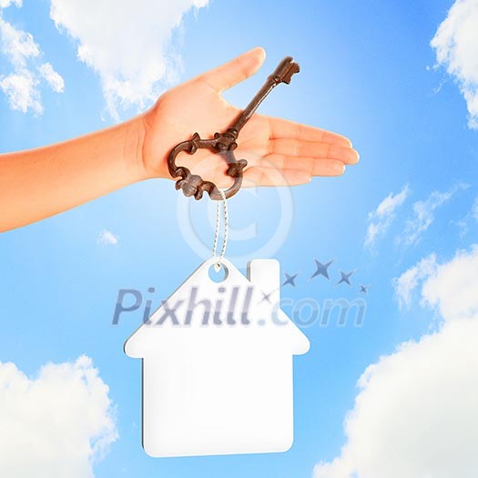 Image of key with blank label in human hand Image of key with blank label in human hand