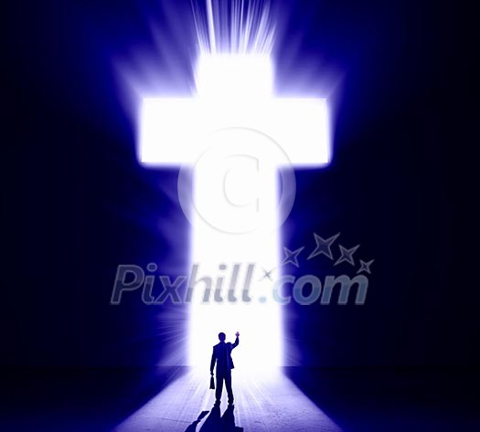 Silhouette of businessman against cross in light Silhouette of businessman against cross in light
